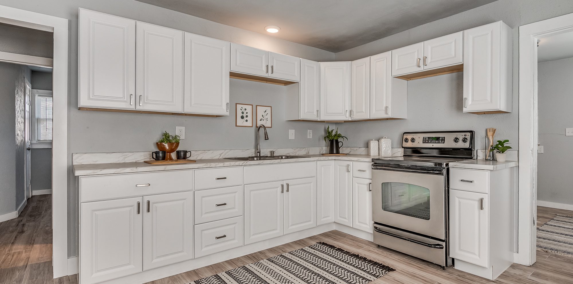 The same kitchen finished, with new cabinets, counters, and appliances